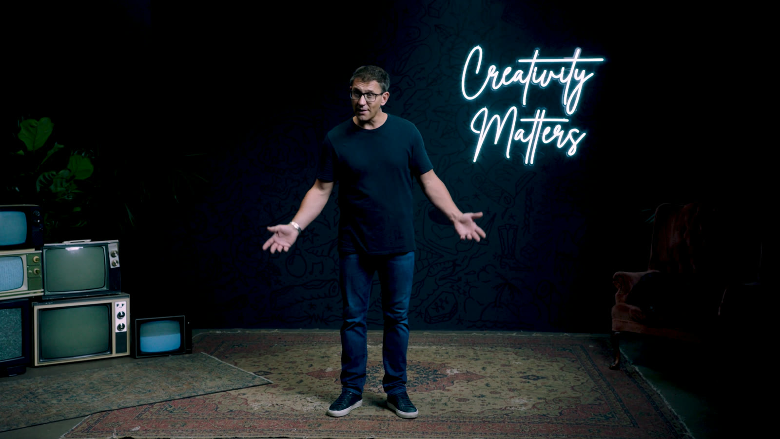 Simon Berg on stage in front of a Creativity Matters neon sign at Power of Creativity 2022